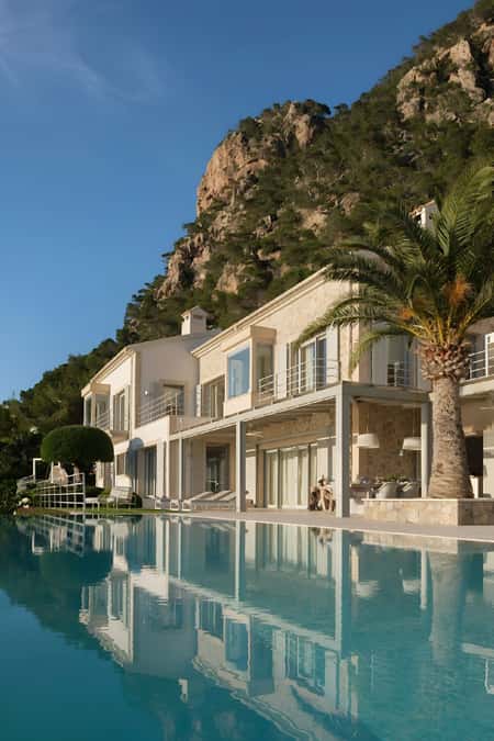 Luxury villa with an infinity pool and views of a cliff overlooking the sea in Mallorca.